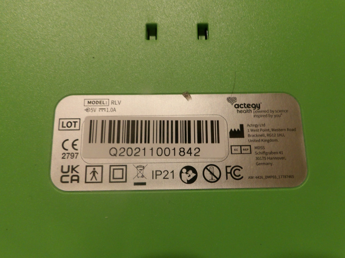 A close-up of a green appliance or device surface with a white product label showing a barcode, model information, and Actegy branding.