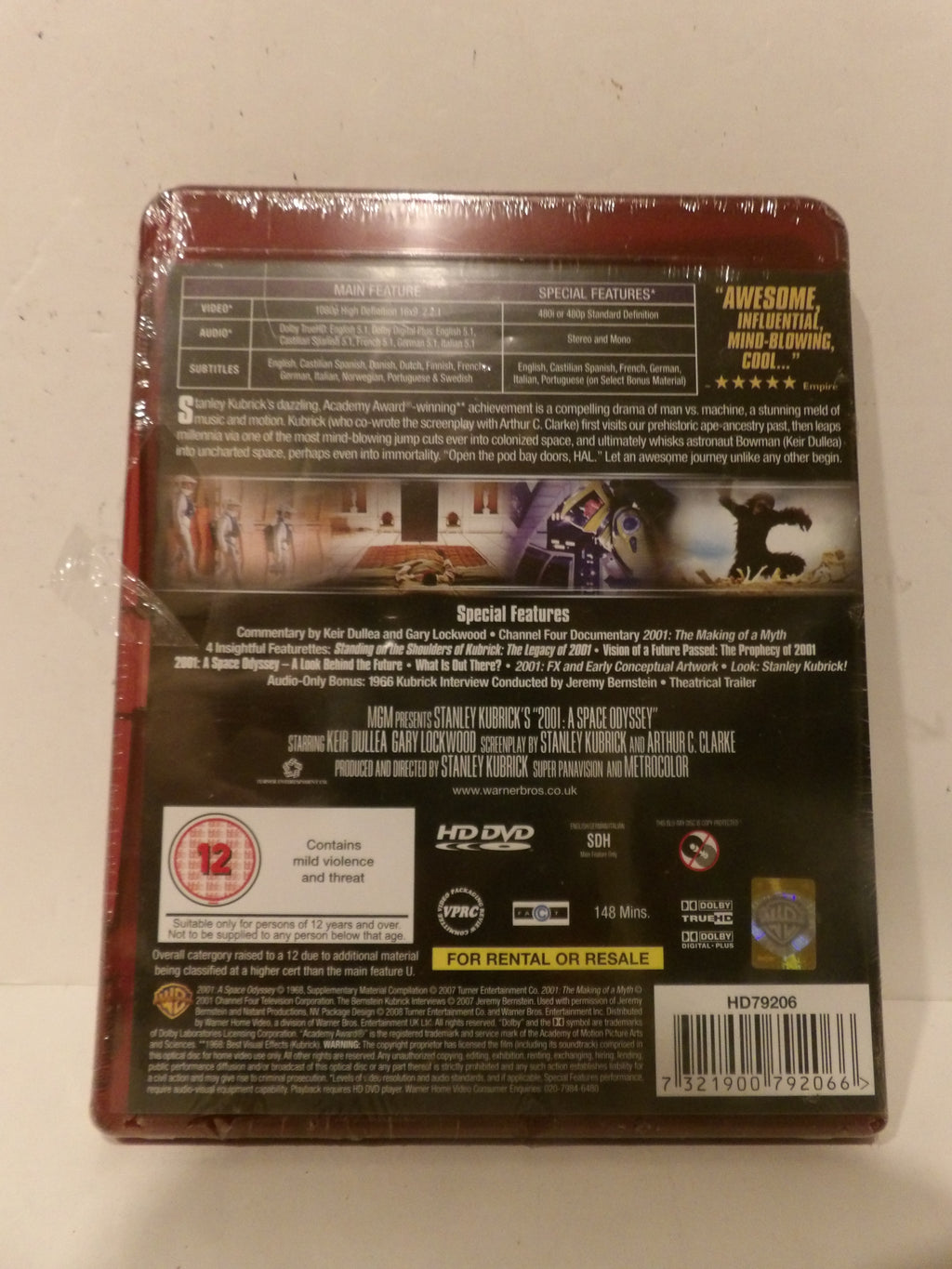 Back cover of a DVD movie case wrapped in plastic, showing title text, synopsis, ratings, and barcode on a light surface.