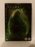 Alien Definitive Edition DVD steelbook case featuring the iconic green bioweapon graphic on a black background, with 18 rating logos in the bottom right corner.