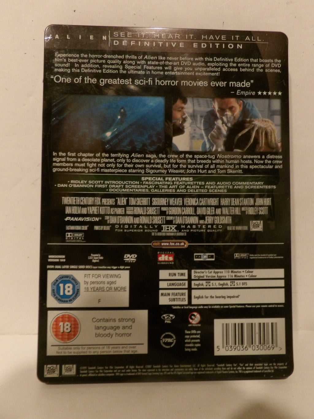 Back cover of the Alien Definitive Edition DVD case, showing the film's synopsis, credits, rating logos, and barcode on a light background.