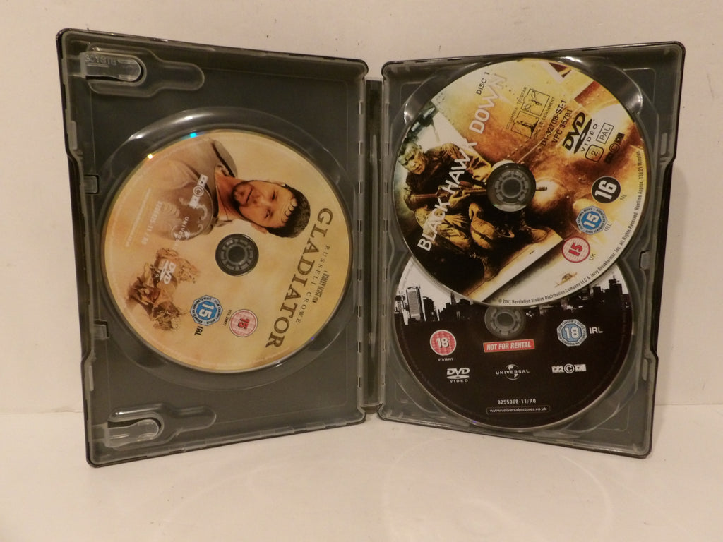 A black plastic DVD case opened flat, showing two discs inside. The left disc has a beige cover with the title 'GLADIATOR', and the right disc features action artwork with the title 'BRAKEMAN OVER'.