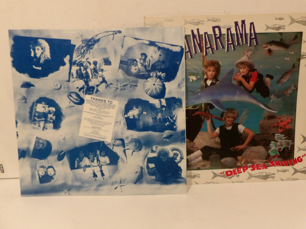 A vinyl record album and its outer sleeve from the band Anarama's 'Deep Sea Shining' are displayed on a light-colored surface. The sleeve features a blue-toned collage of photos with a 'THANKS TO' note, while the front cover shows the band members underwater with the title 'ANARAMA' and 'DEEP SEA SHINING' in red.