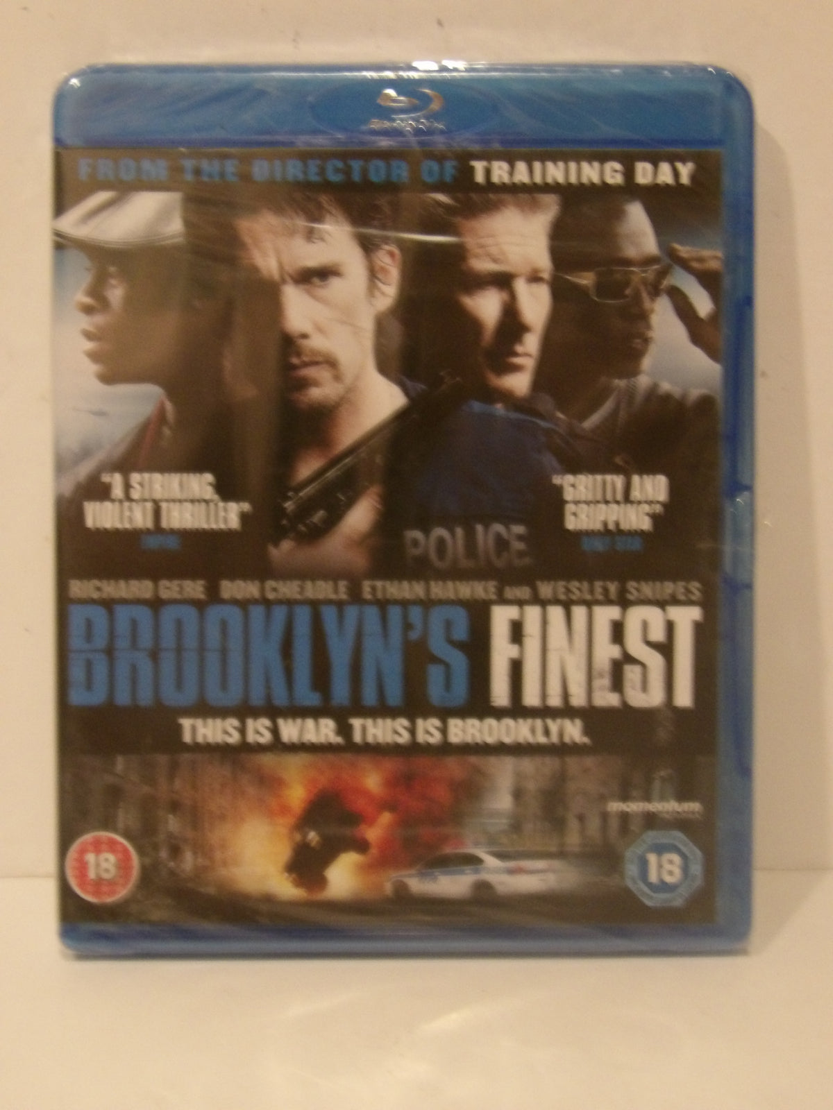Brooklyn's Finest Blu-ray movie case with a blue plastic shrink wrap, featuring the cast on the cover and a police car scene at the bottom.