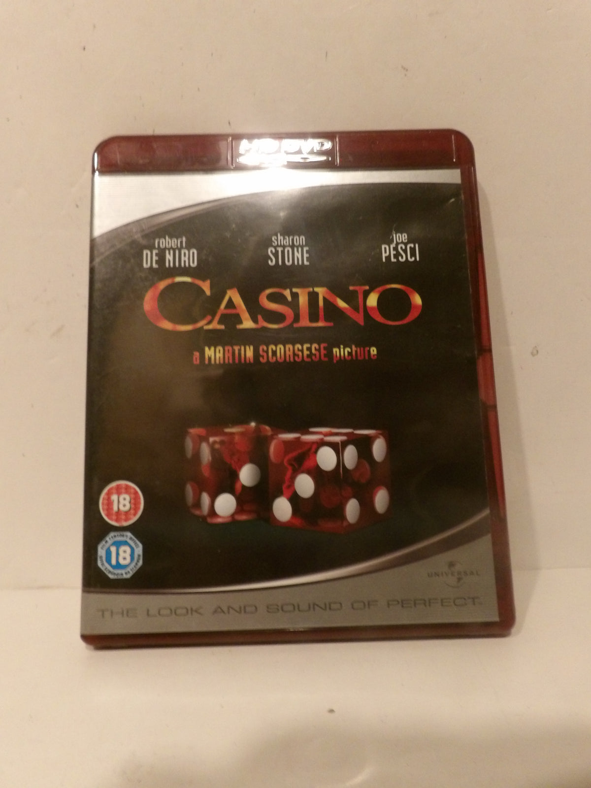 Casino movie Blu-ray case with a dark cover featuring the title in red and gold, plus two red dice with white pips, photographed against a plain off-white background.