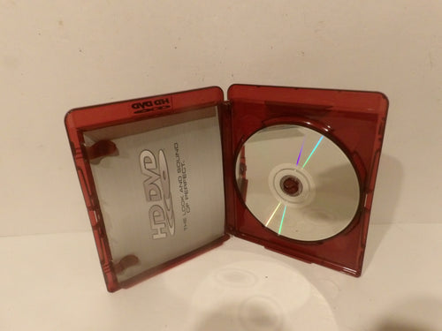 An open translucent red plastic DVD case with a silver DVD disc inside, photographed against a plain off-white background.