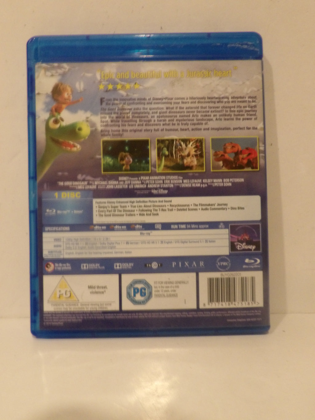 The back cover of a Disney Pixar film Blu-ray case, showing the title 'The Good Dinosaur' and product details, photographed against a plain light background.