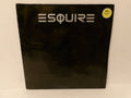 A black vinyl record sleeve for the band Esquire, featuring their name in a stylized white font at the top. A small yellow circular sticker is visible in the upper right corner, and the sleeve is photographed against a plain off-white background.