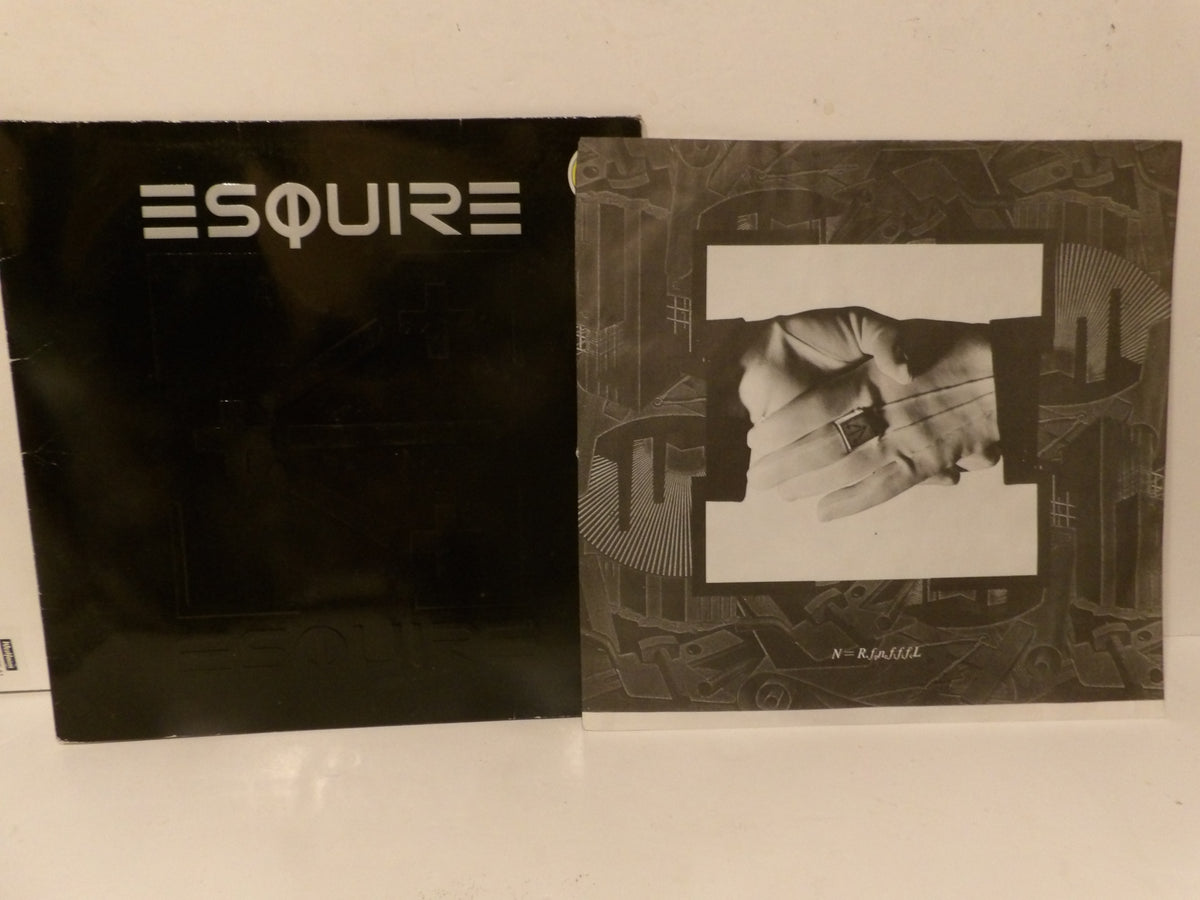 Two vintage Esquire magazine issues, one black with white 'ESQUIRE' text and the other black-and-white with a central portrait cutout, resting on a white surface against a white wall.