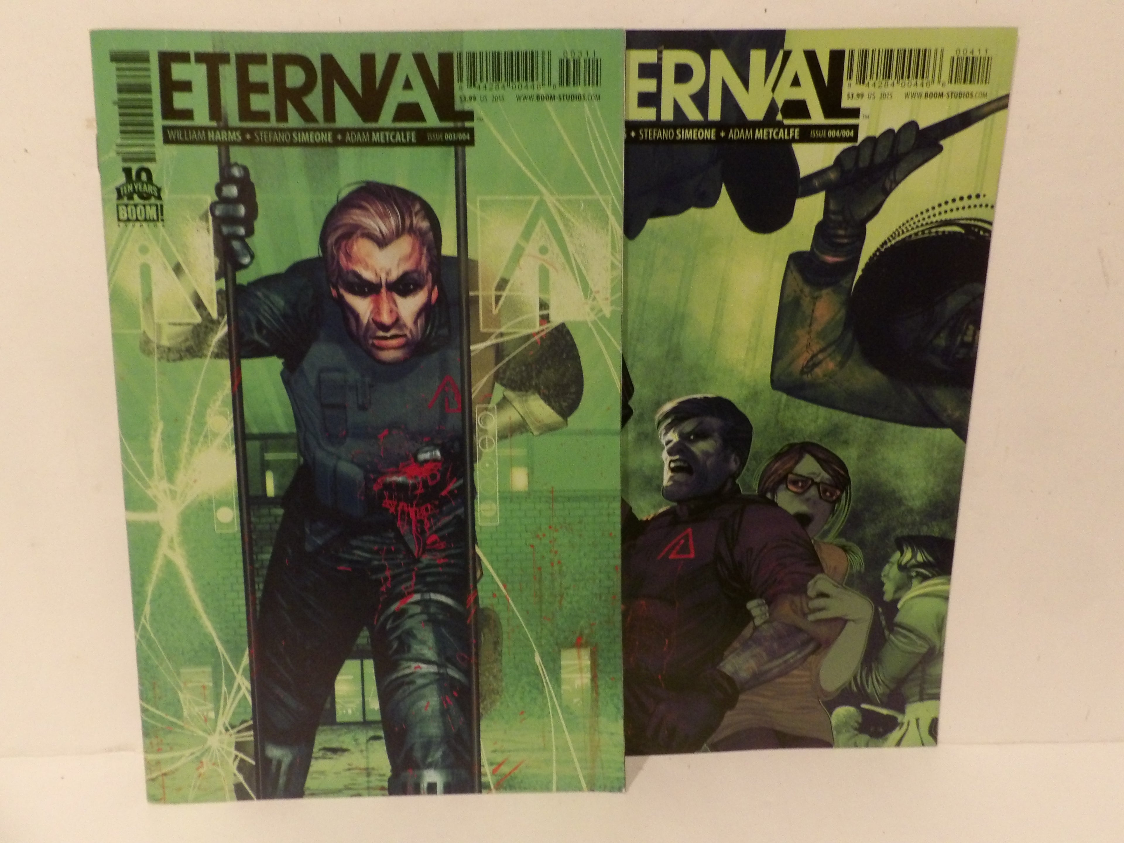 Two copies of the comic book ETERNAL #10, one with a green cover featuring a man in a black suit and the other with a green cover featuring a man holding a gun, displayed on a white background.