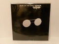 Fear of the Dark (Grittap) album cover by Gordon Giltrap, featuring a black background with a pair of round silver-framed sunglasses in the center, photographed inside a clear plastic sleeve.