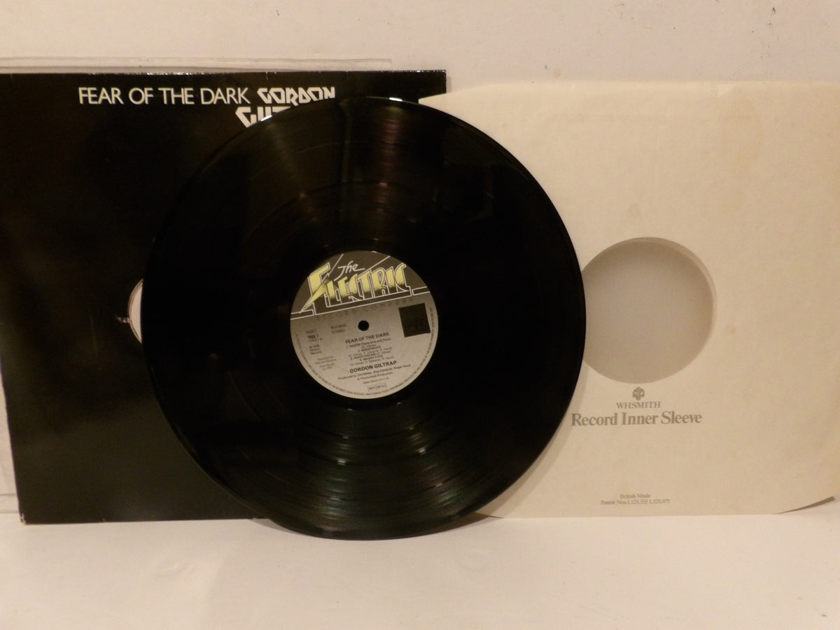 A vinyl record partially pulled from its black outer sleeve, with a cream-colored inner sleeve visible behind it. The record label reads 'Fear of the Dark' and 'Sorrow' with 'The Sexually Dangerous' in stylized text.