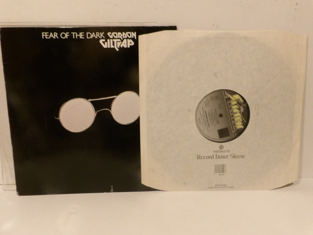 A vinyl record sleeve for Gorbion Gittap's 'Fear of the Dark' next to its off-white paper inner sleeve, displayed on a white surface.