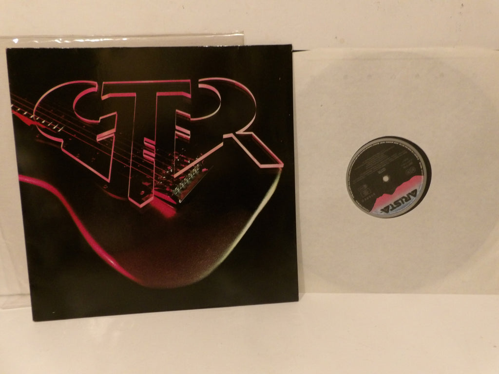 A vinyl record partially pulled from its sleeve, showing a black cover with a stylized pink and red electric guitar graphic and the letters 'CTR'. A white translucent vinyl disc is visible beside the sleeve.