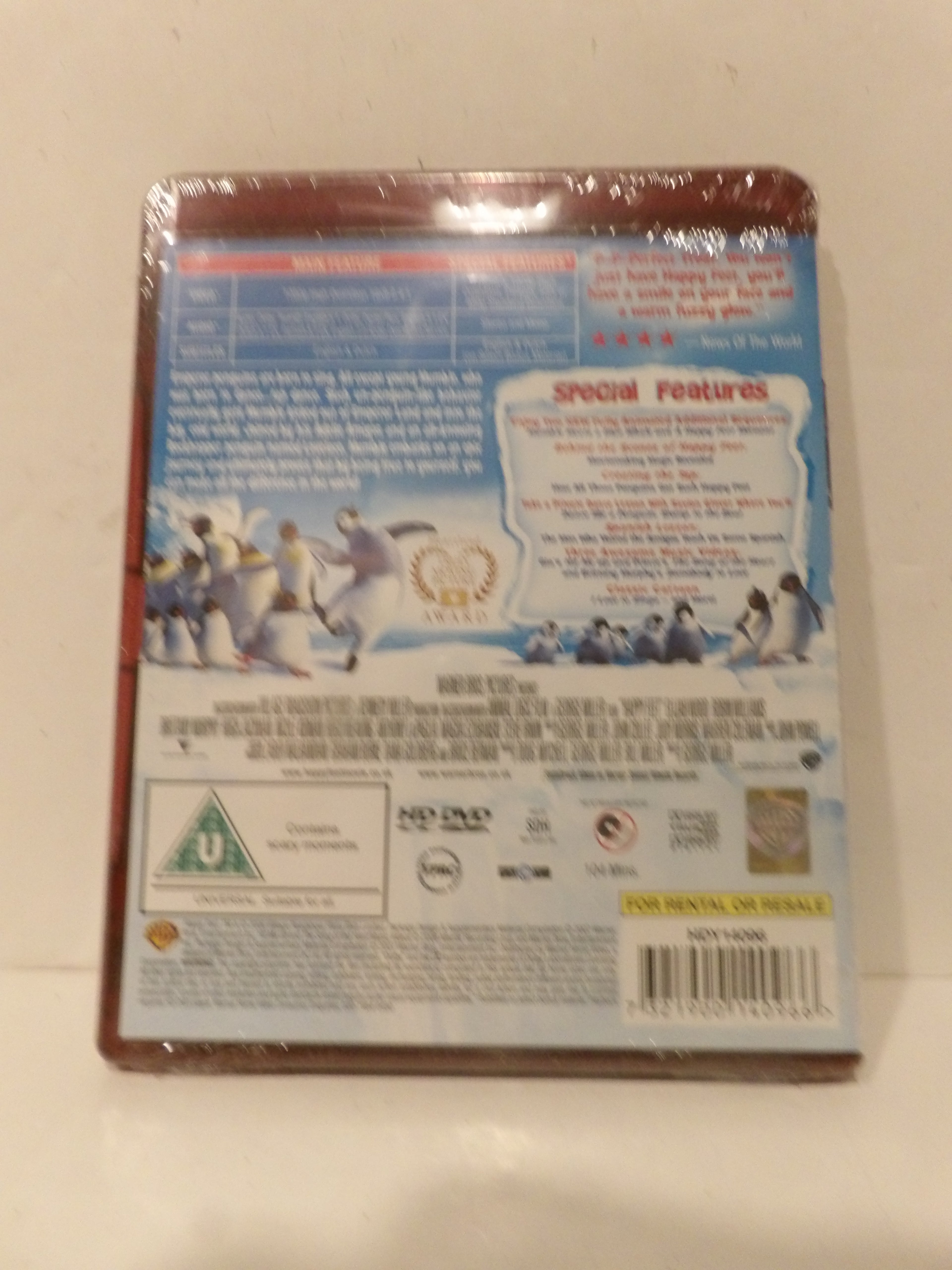 The back cover of a DVD case for 'Ice Age: The Great Meltdown', sealed in plastic shrink wrap, photographed against a light beige background.