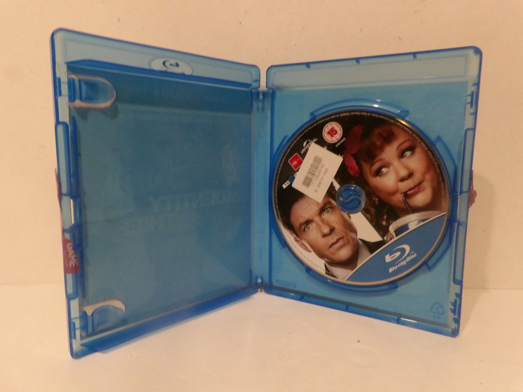 An open blue Blu-ray case showing a movie disc with printed character portraits, photographed against a plain light background.
