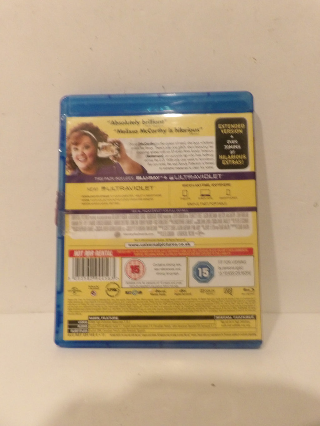 The back cover of a Blu-ray case for the movie 'Absolutely Scandalous' featuring Madeline McCorkley, photographed against a plain off-white background.