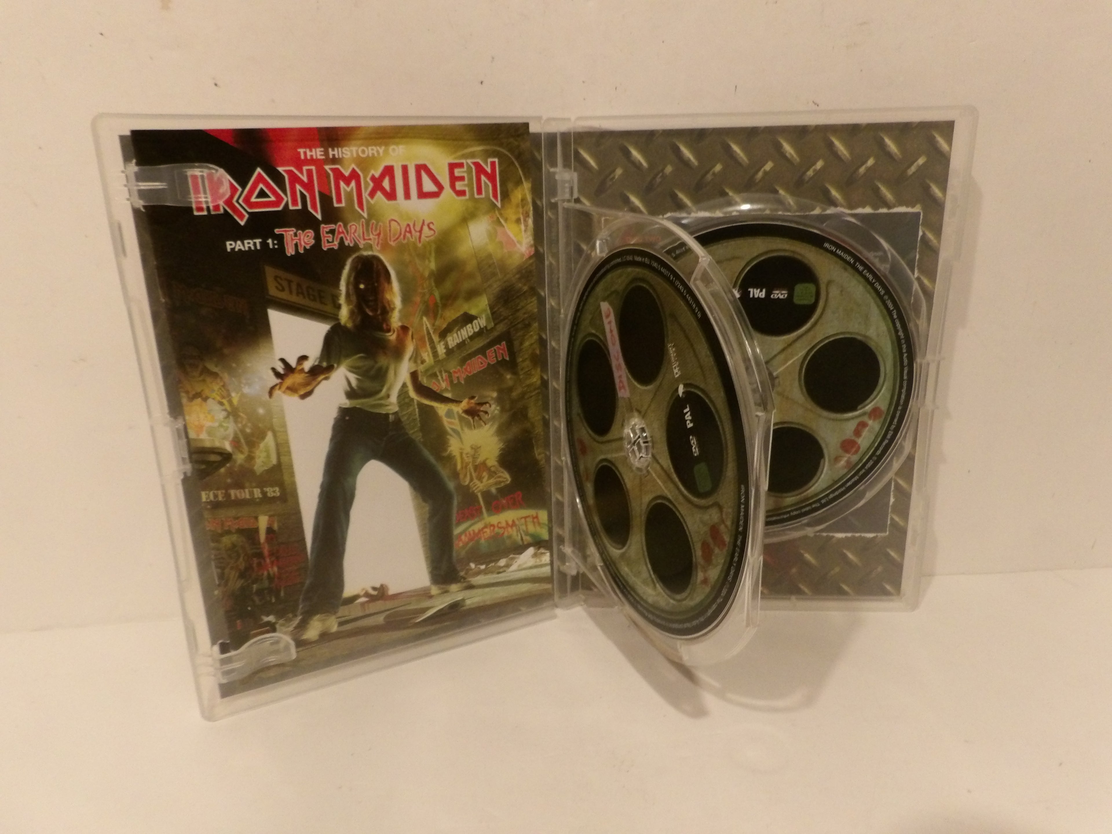 Iron Maiden 'The Trooper' Part 1 DVD case shown open, with the printed cover on the left and two DVD discs visible inside the clear plastic case on a white surface.