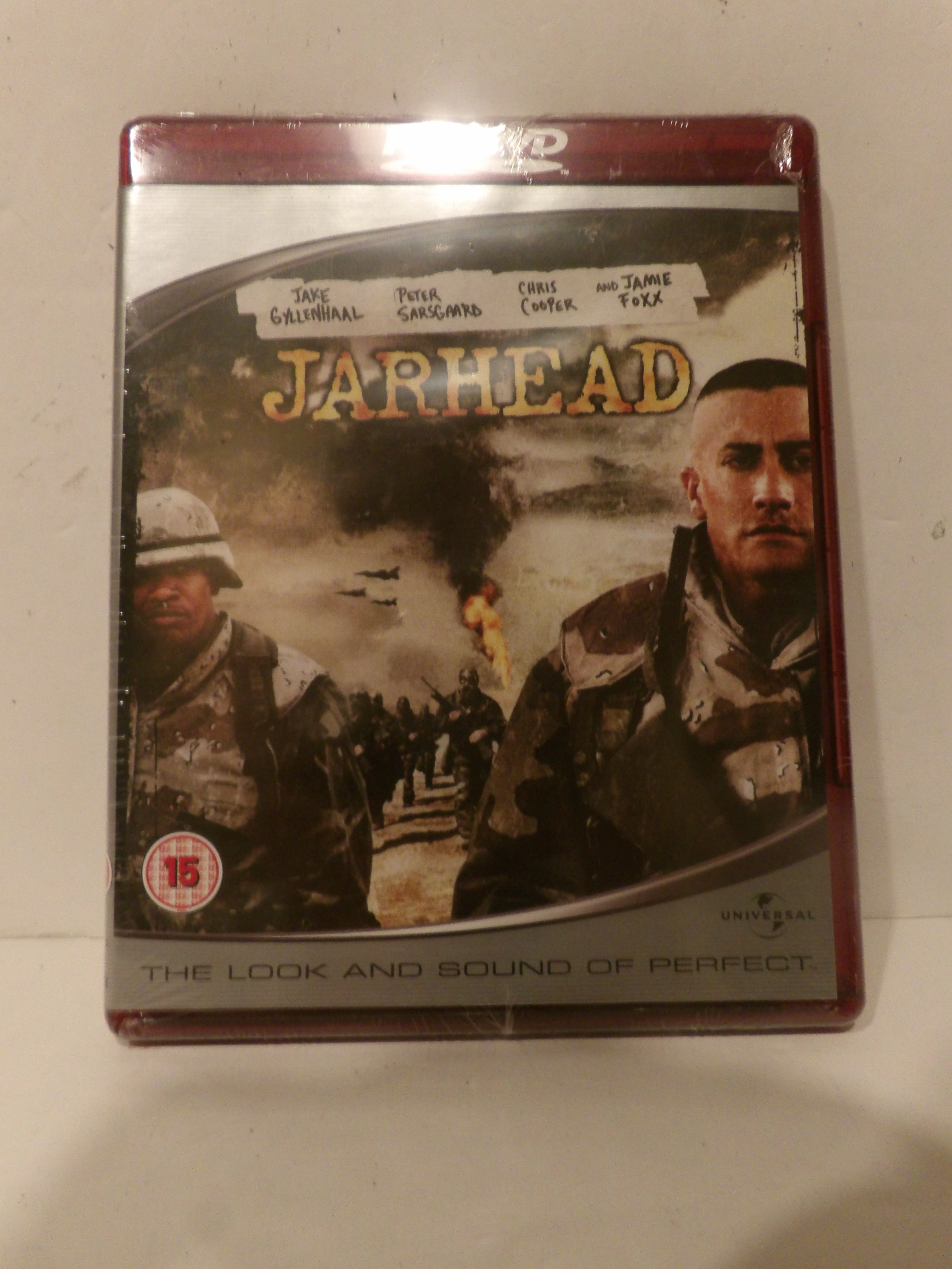 A DVD case for the movie 'Jarhead' on a plain light background. The cover shows military scenes with two soldiers and the title 'Jarhead' in large gold letters.