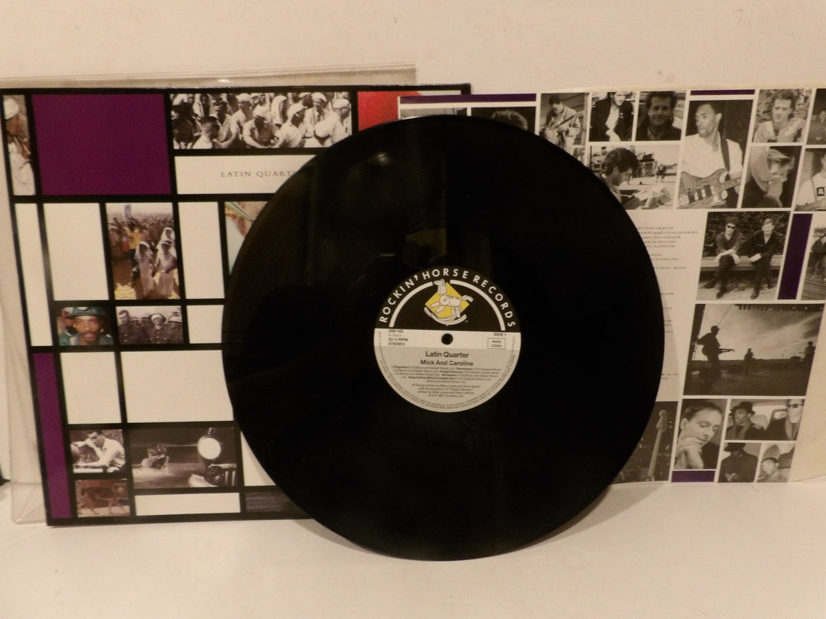 A black vinyl record from Archy Morse Records leaning against its printed sleeve, which features a grid of black-and-white photos and purple blocks.