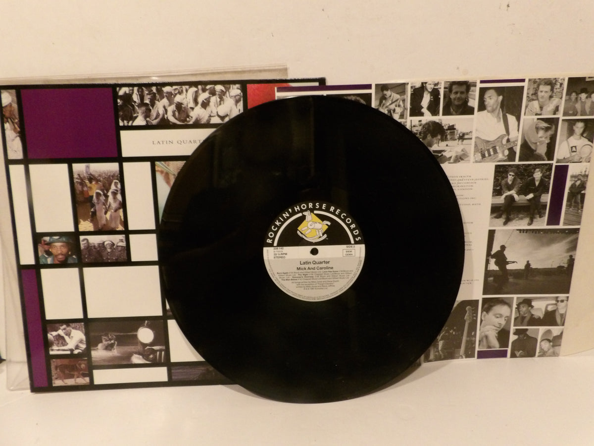 A black vinyl record with a white and gold Documult Records label, displayed in front of its illustrated album cover featuring a grid of black-and-white photos and purple accents.