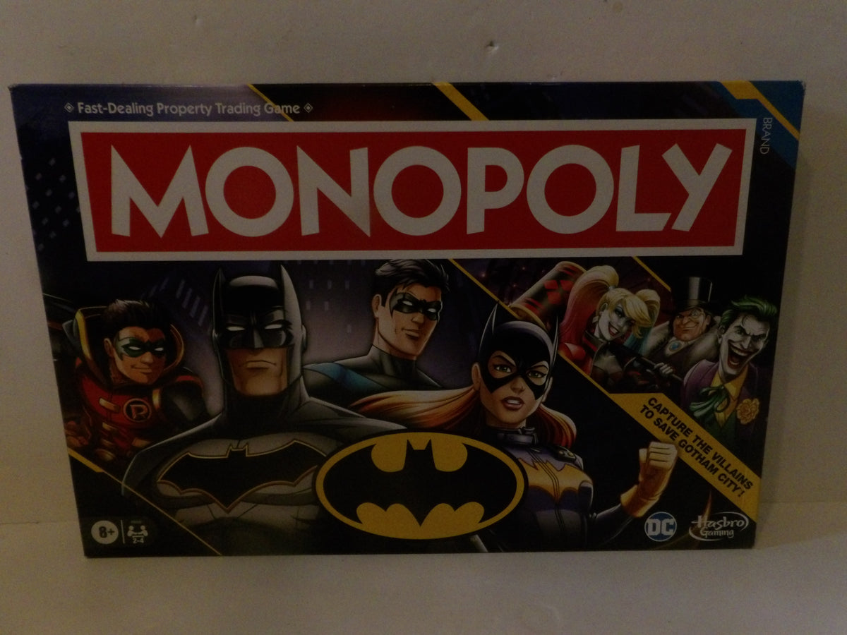 Hasbro's Batman Monopoly board game box, featuring Batman, Robin Hood, and other DC characters on the illustrated packaging.