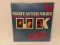 UK Night After Night Live! vinyl record album cover, sealed in plastic shrink wrap, featuring a blue background with red and cream text and three band member photos.