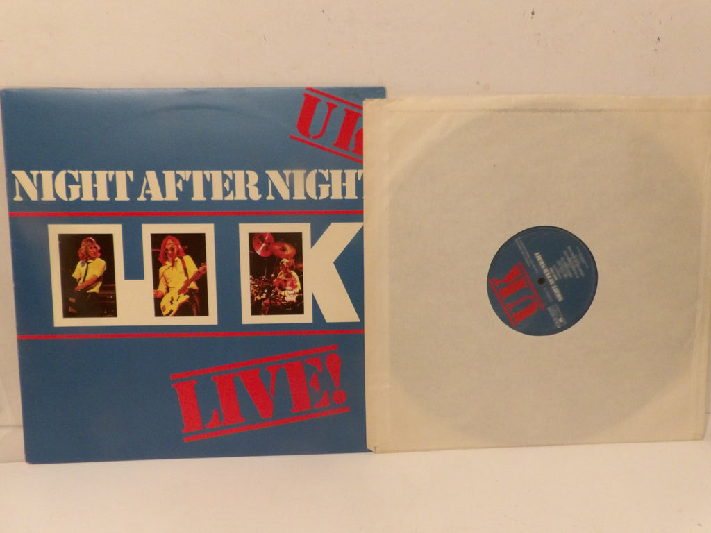 A vinyl record sleeve for 'Night After Night Live!' with a blue cover featuring white and red text and three small performer photos, shown next to a partially pulled-out cream-colored record on a plain light background.