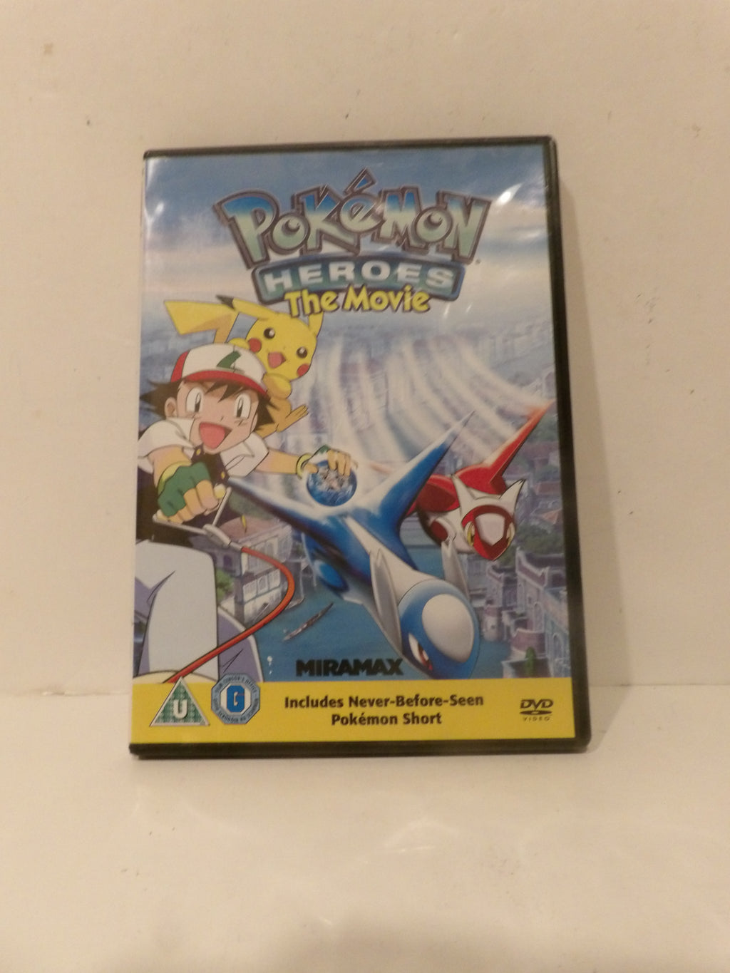 Pokémon Heroes: The Movie DVD cover shown standing upright against a plain off-white background.
