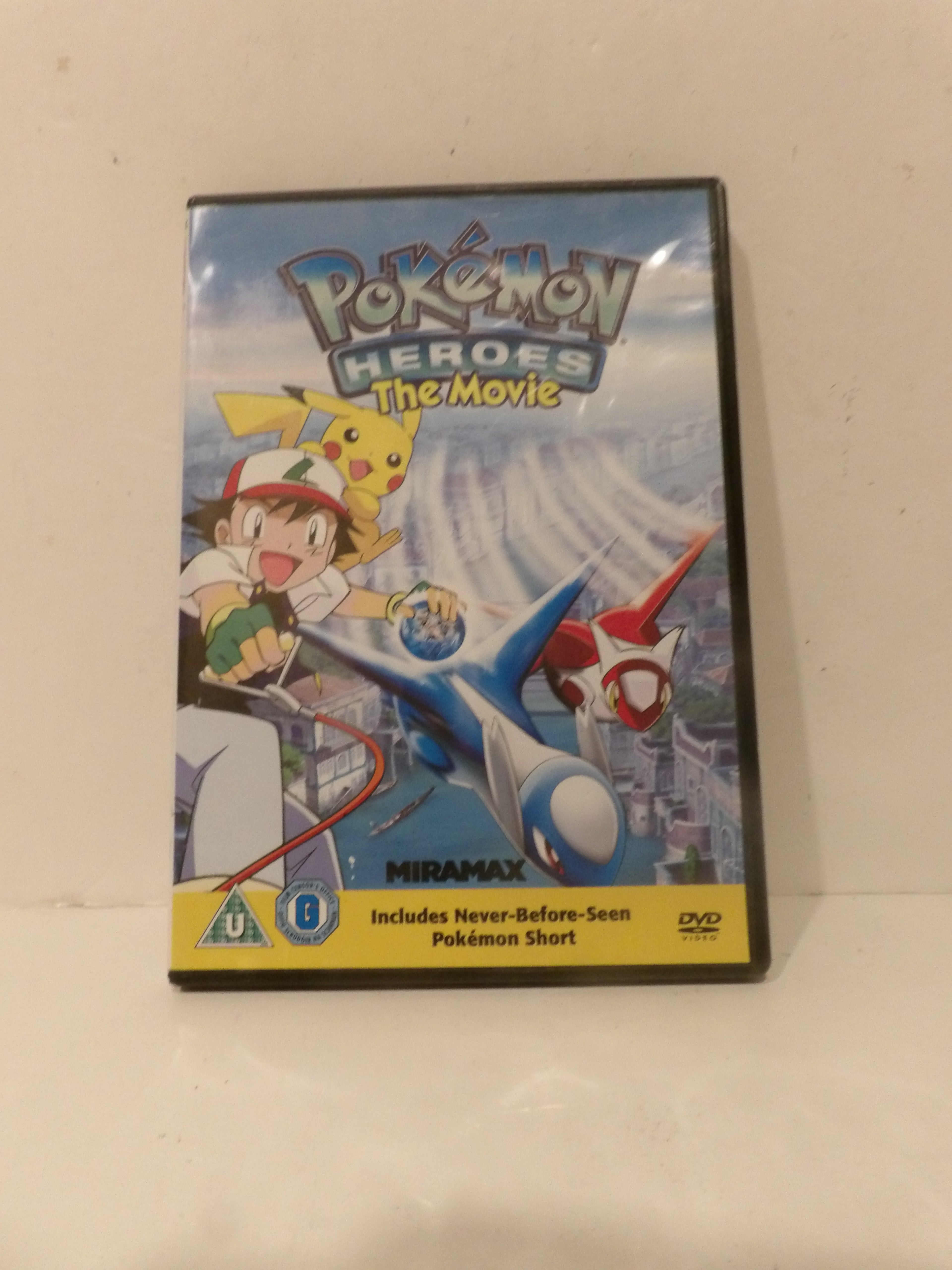 Pokémon Heroes: The Movie DVD cover shown standing upright against a plain off-white background.