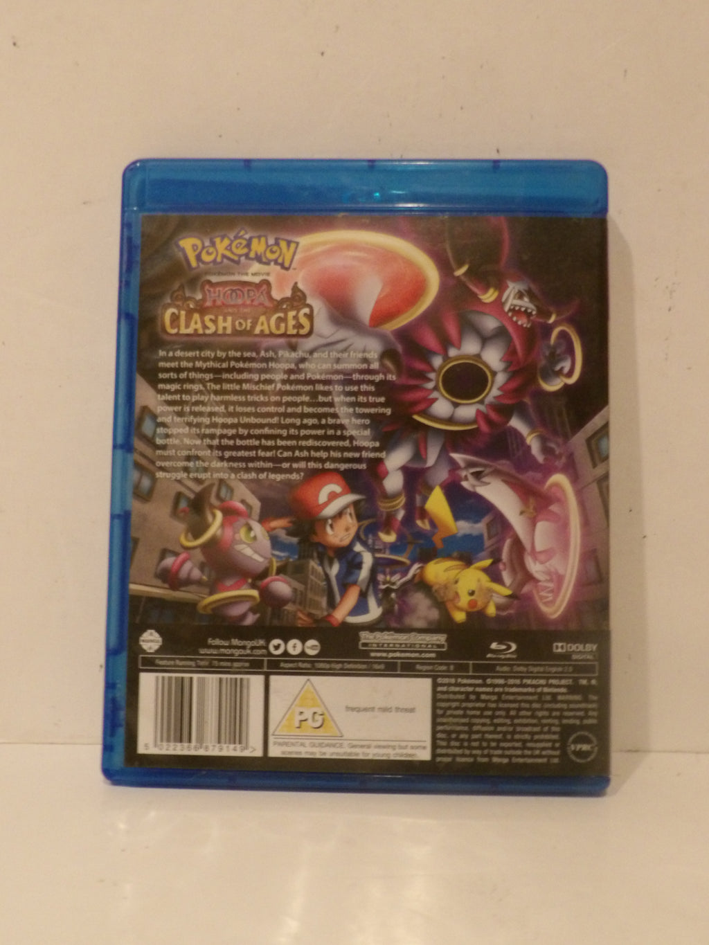 The back cover of a Pokémon: Mirror, and Clash of Ages video game on Blu-ray, shown in its blue plastic case against a plain off-white background.