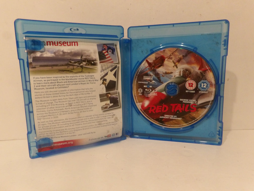 A Blu-ray movie case opened flat, showing the back cover on the left and the disc on the right. The disc features the title 'RED TAILS' in red text over a war scene, and the case back includes printed descriptions and images.