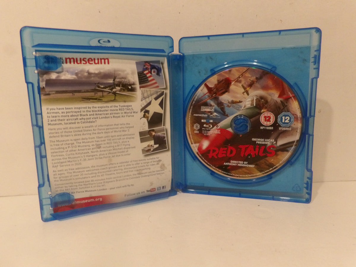 A Blu-ray movie case opened flat, showing the back cover on the left and the disc on the right. The disc features the title 'RED TAILS' in red text over a war scene, and the case back includes printed descriptions and images.
