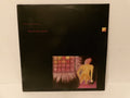 A vinyl record sleeve for Richie Lee Jones, featuring a black background with red text and a small square painting of a figure in yellow near a window.