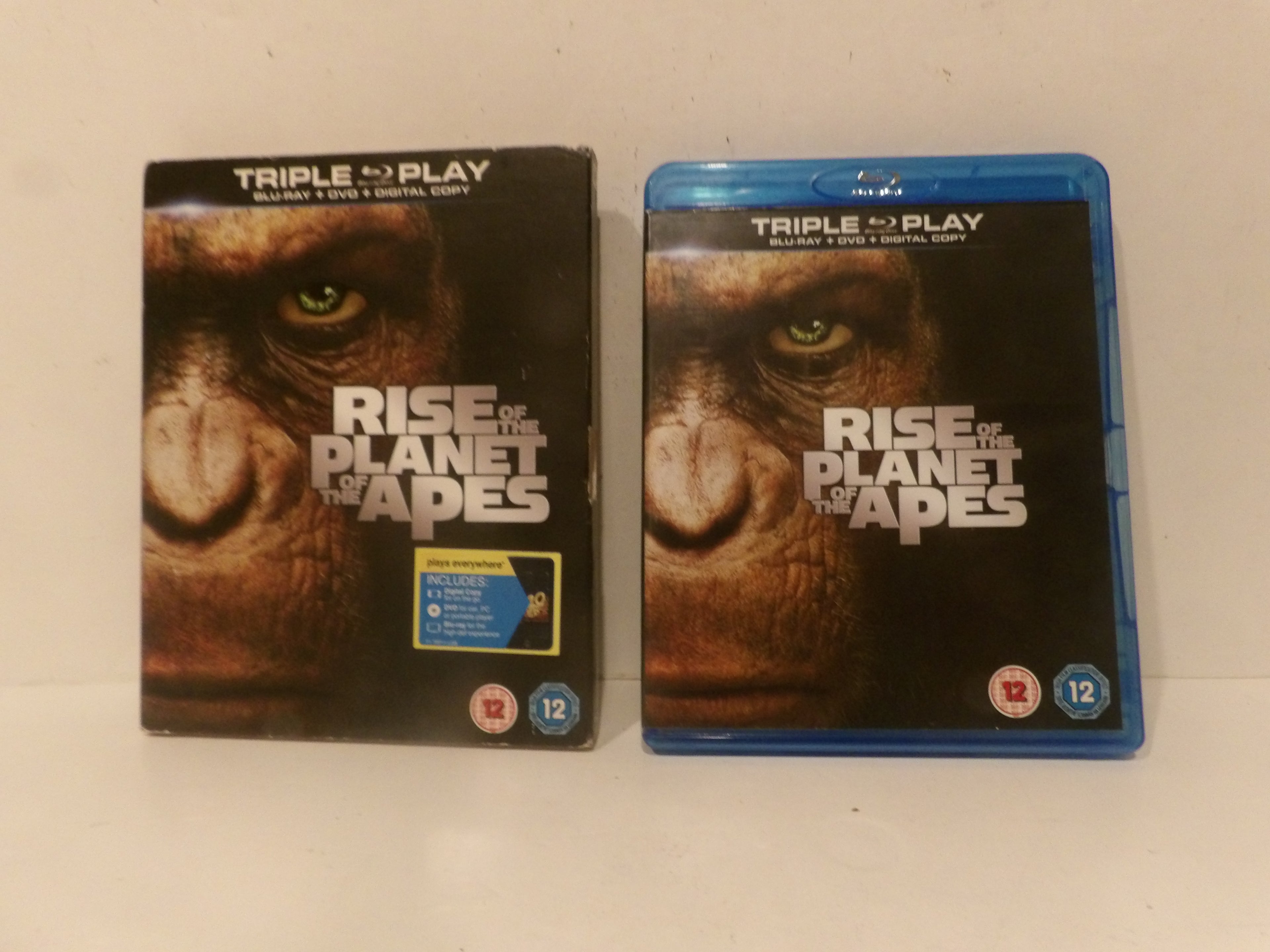A physical copy of 'Rise of the Planet of the Apes' shown as both the DVD box set and Blu-ray case side by side on a plain light background.