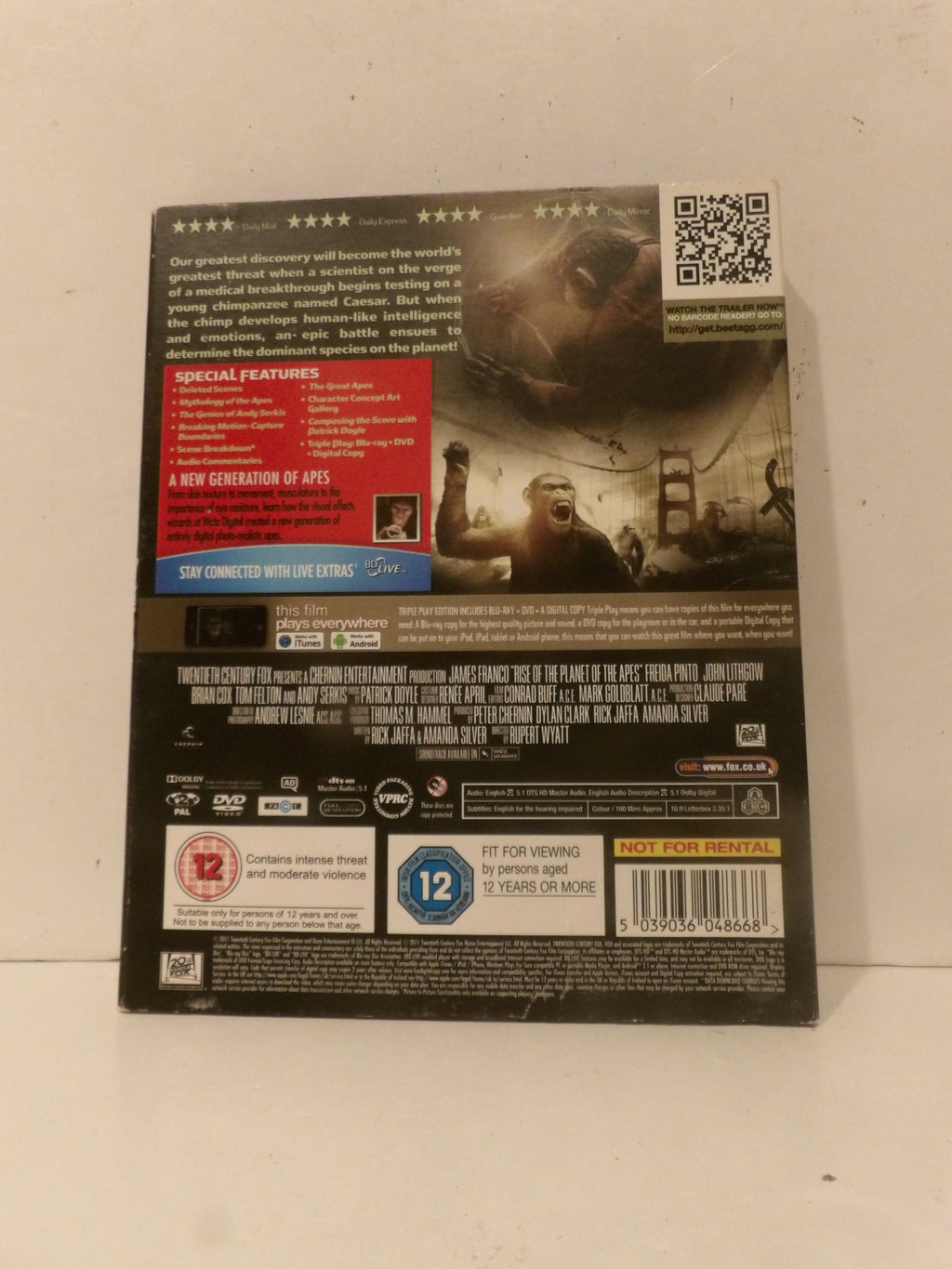 Back cover of a DVD case for 'The Island' movie, photographed against a plain off-white background. The cover features a dark design with a stormy scene, a red 'Special Features' box, a QR code, and a 12 age rating badge.