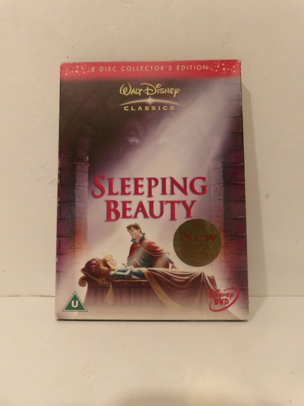 A boxed Disney Classics 'Sleeping Beauty' 4-disc collector's edition DVD set, photographed standing upright against a plain off-white wall. The cover shows the title in large red letters, Walt Disney Classics branding at the top, and artwork of Princess Beauty and the prince in a castle corridor.