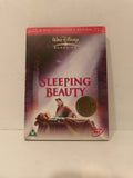 A boxed Disney Classics 'Sleeping Beauty' 4-disc collector's edition DVD set, photographed standing upright against a plain off-white wall. The cover shows the title in large red letters, Walt Disney Classics branding at the top, and artwork of Princess Beauty and the prince in a castle corridor.