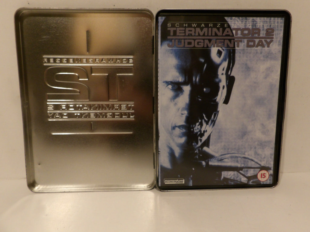 Terminator 2: Judgment Day collectible steel tin case shown open, displaying the metallic silver interior with 'ST' lettering and the front cover featuring Arnold Schwarzenegger.