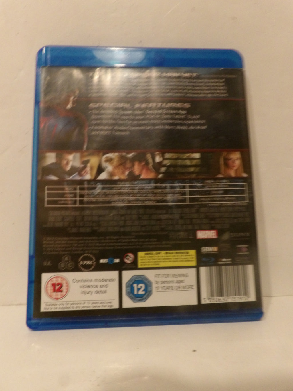 The back cover of a Marvel movie Blu-ray case, showing the blue plastic case edge, movie title text, cast images, rating logos, and a barcode on a light-colored surface.