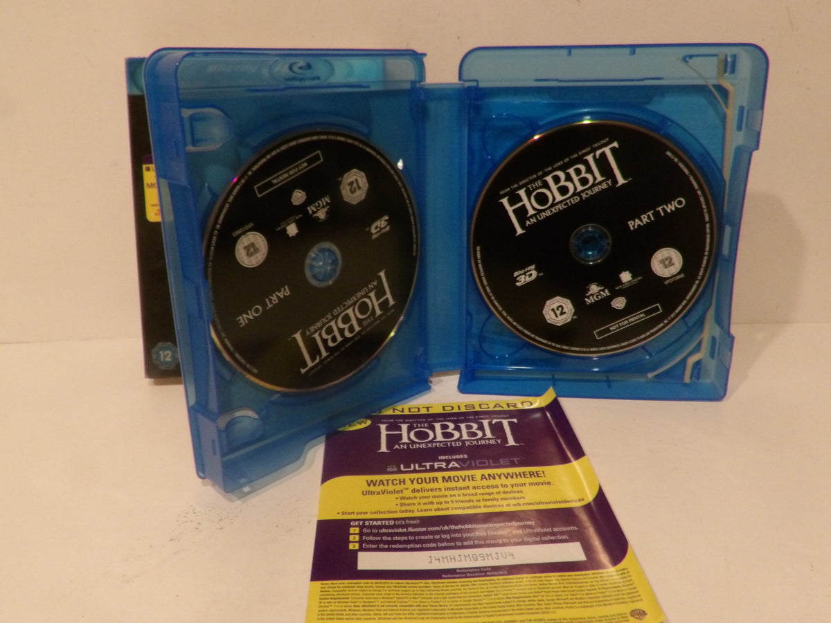A Blu-ray copy of The Hobbit: The Desolation of Middle-earth Part Two, shown with its blue plastic case open, two black discs, and a yellow-and-purple booklet on a plain light background.