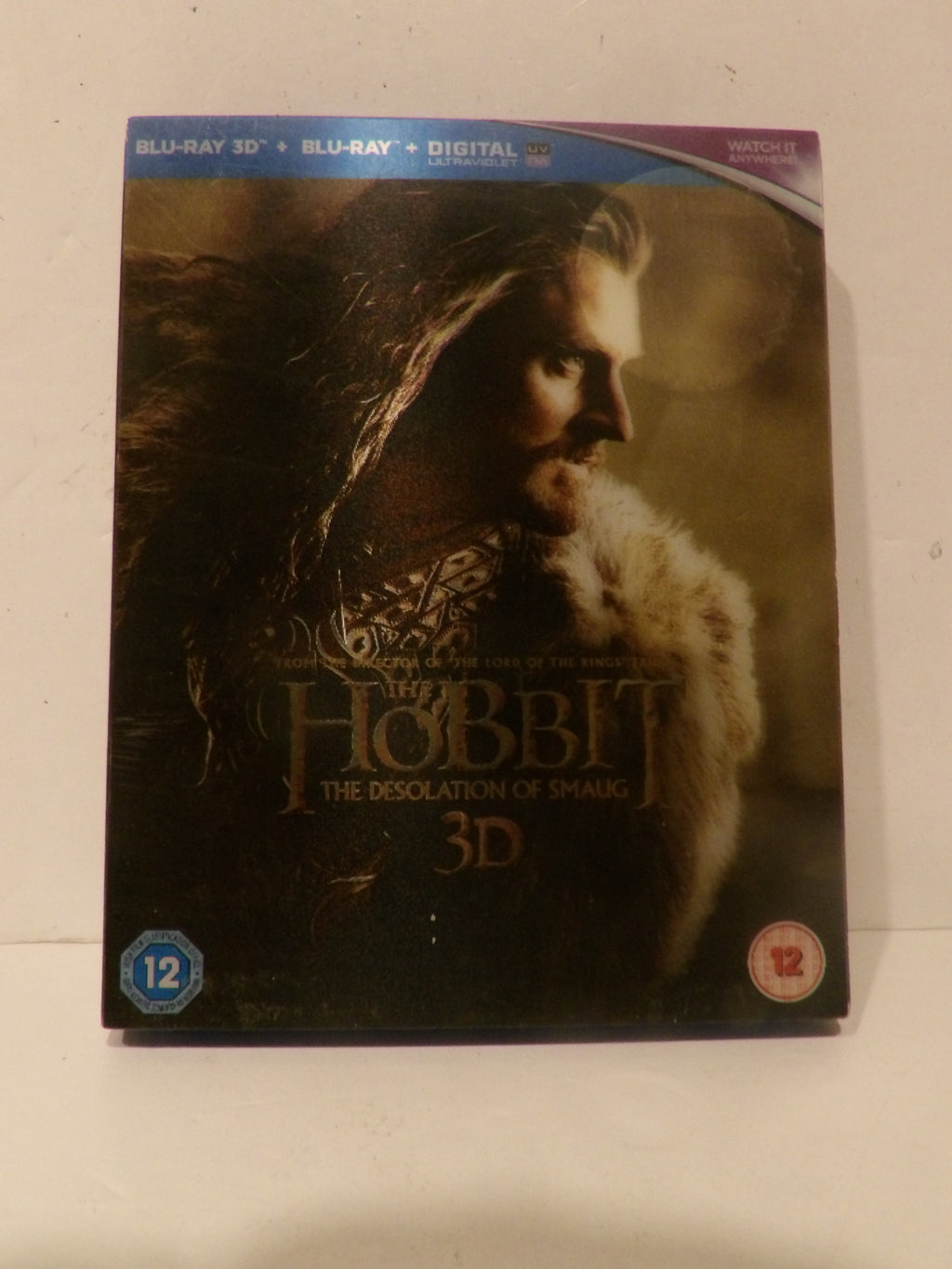 The Hobbit: The Desolation of Smaug 3D Blu-ray case, featuring a dark cover with a portrait of Smaug and the movie title, photographed on a light surface.