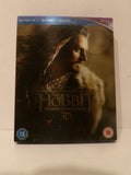The Hobbit: The Desolation of Smaug 3D Blu-ray case, featuring a dark cover with a portrait of Smaug and the movie title, photographed on a light surface.