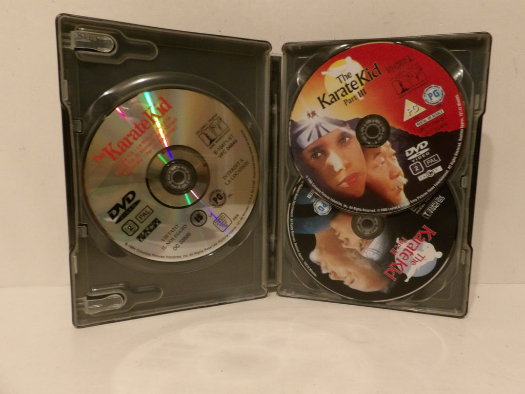 Open black DVD case containing three discs from The Karate Kid The III, photographed on a plain light background.