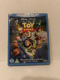 Disney Pixar Toy Story 3 Double Play Blu-ray and DVD case, featuring Buzz Lightyear and other characters on the cover, photographed on a light beige surface.