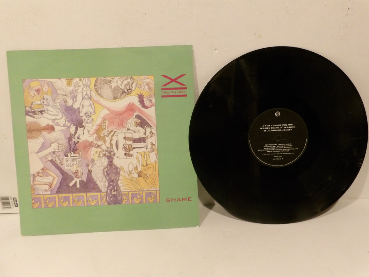 A vinyl record and its sleeve from the band Shame, featuring a light green sleeve with a colorful abstract illustration and a black 12-inch record partially pulled from the sleeve.