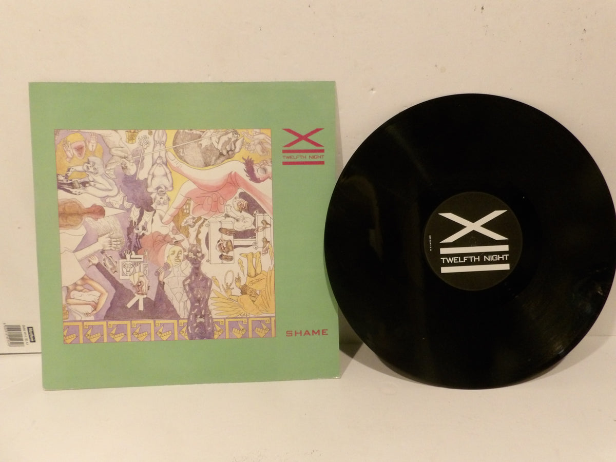 Twelfth Night 'Shame' vinyl record with its illustrated green outer sleeve, displayed on a plain off-white surface.