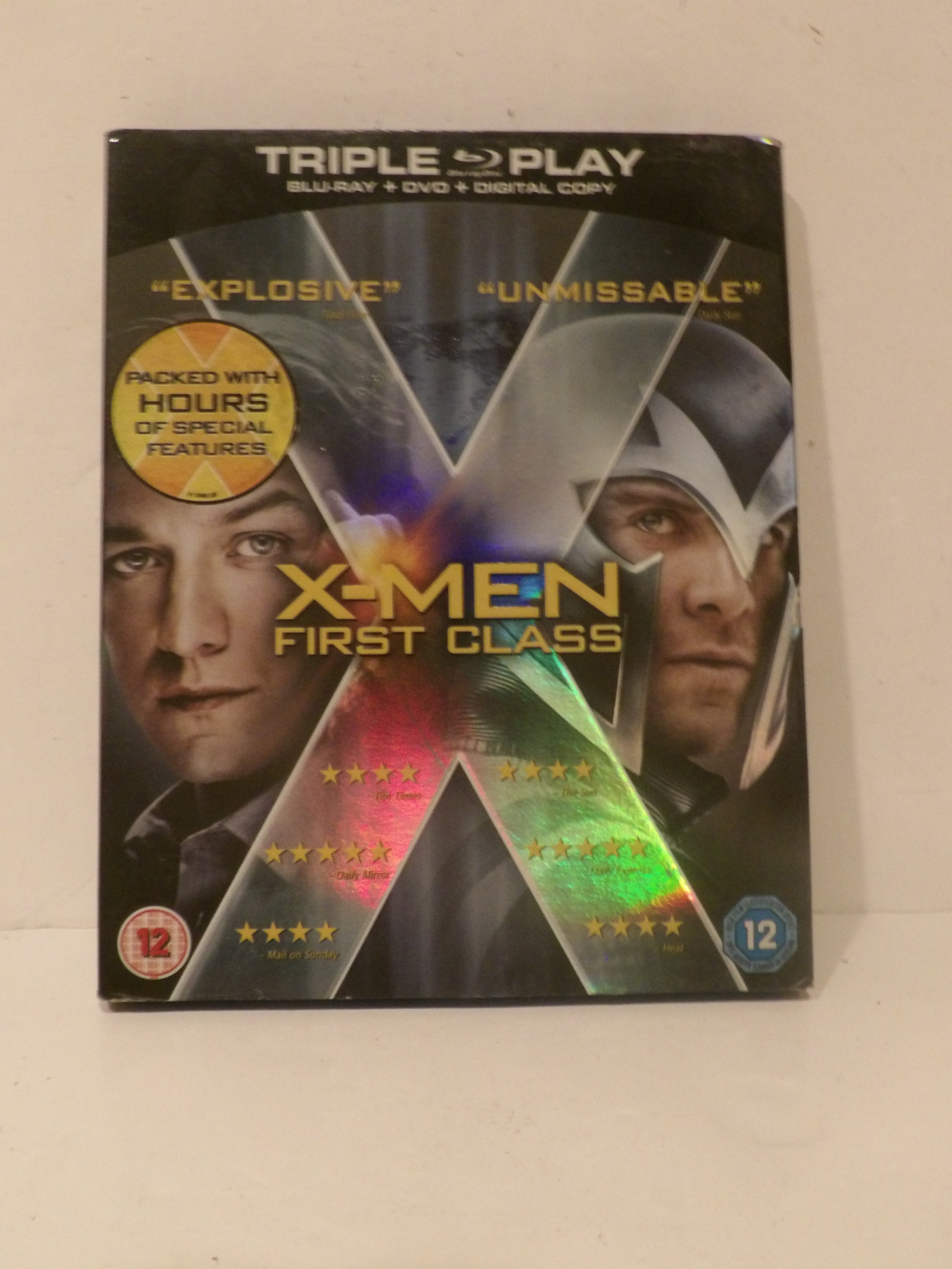 X-Men: First Class movie Triple Play Blu-ray, DVD, and digital copy combo pack on a light beige background.